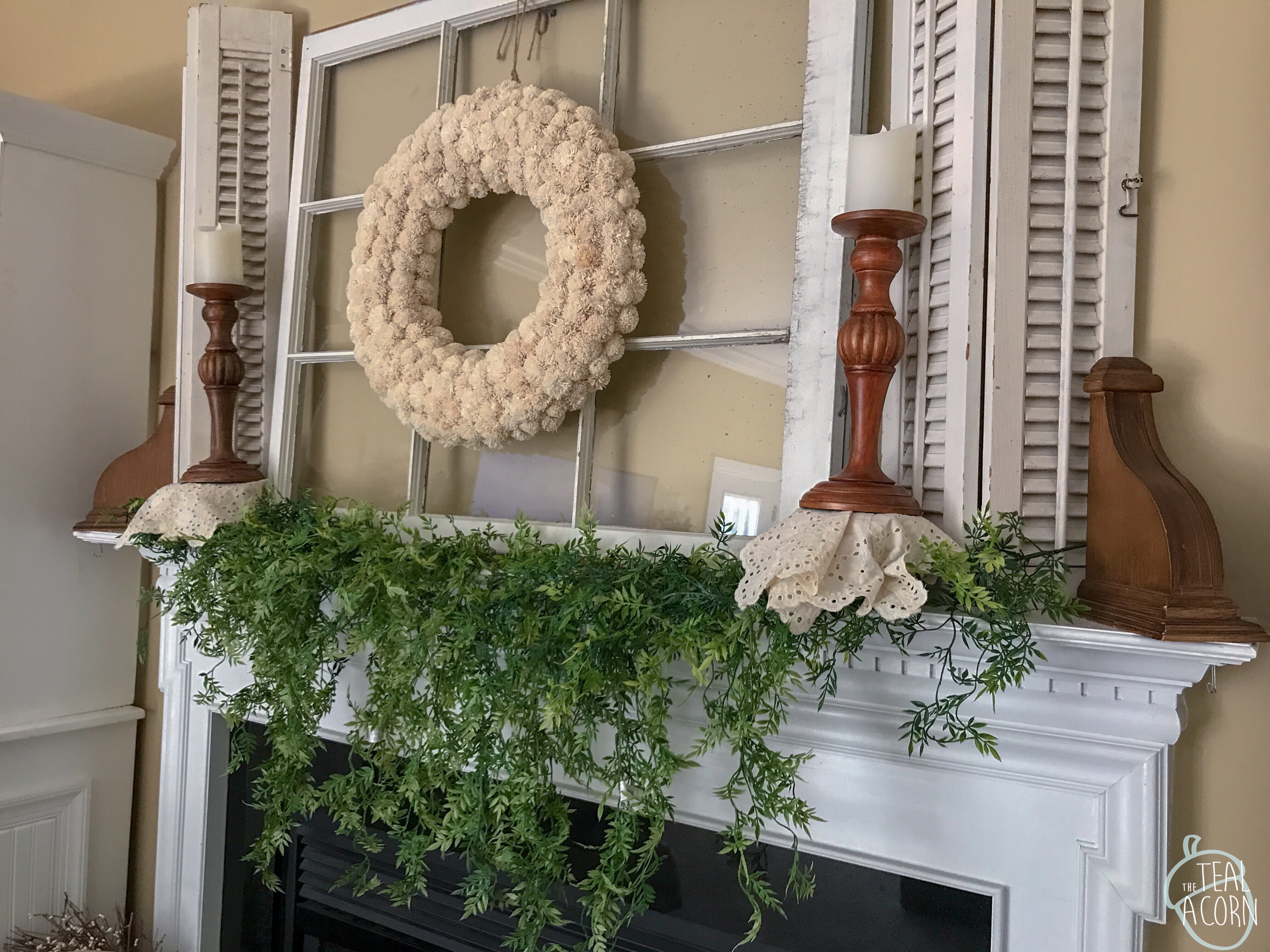 Spring mantle with draping ficus greenery, old window above mantle, and old shutters above mantle 